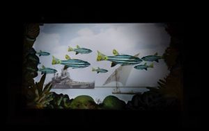 Artwork: A ship seen trough the aquarium