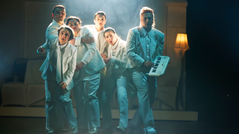 A band on the stage, dressed all in white