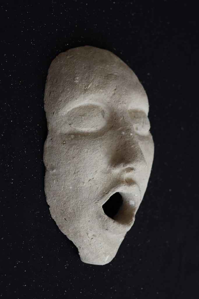 Photo: clay-made artwork depicting a face with mouth wide open